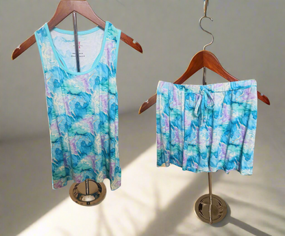 Tie-dye tank top and shorts set on hangers with a white background